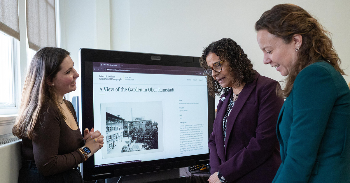 Student presents research on a large screen.