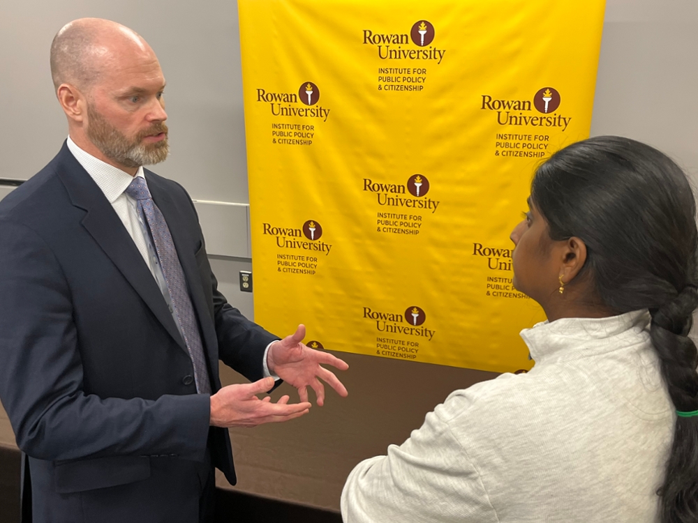 Brian Alpert speaking with a student