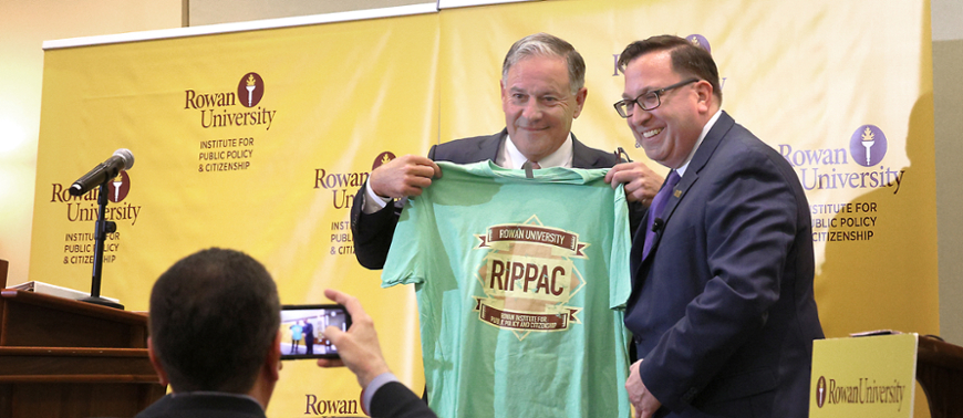 2025 gubernatorial candidate Jon Bramnick holds a RIPPAC T-shirt