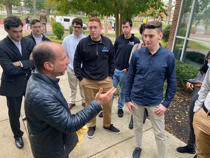 Ronald Ladell and Students Outside Savitz Hall