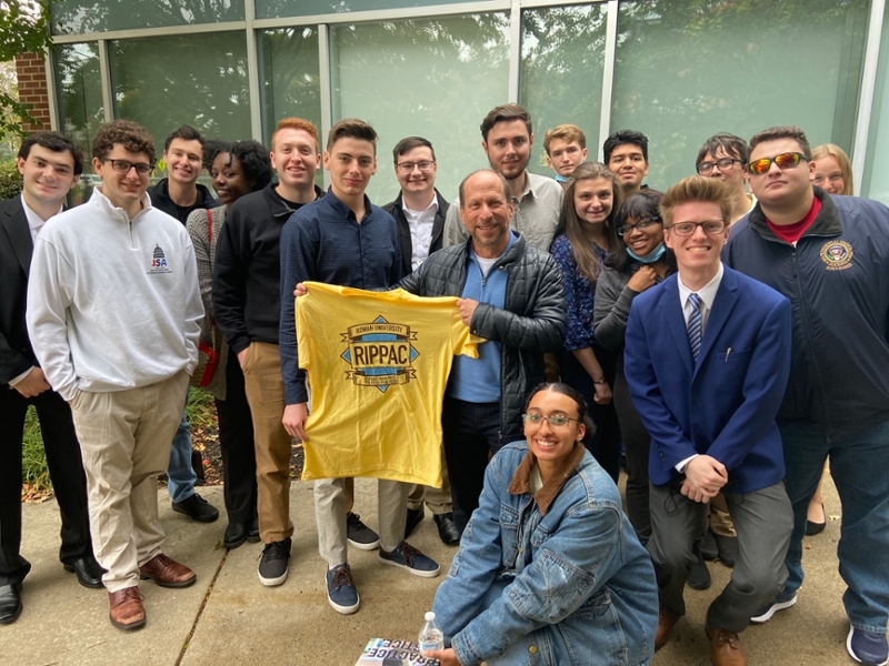 Ron Ladell with students displaying RIPPAC t-shirt